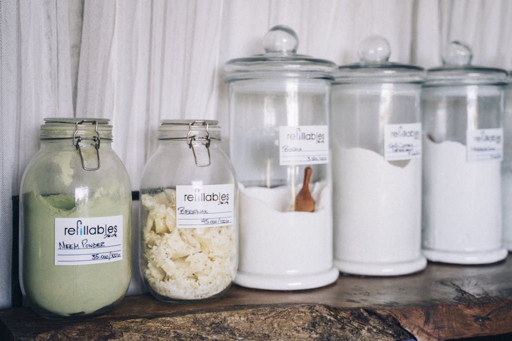 Assorted refillable glass jars containing organic products on display.