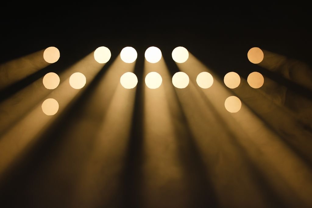 Abstract display of light beams creating a captivating circular bokeh effect in a dark environment.