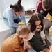A vibrant scene of teenagers enjoying pizza indoors, capturing the essence of school life.