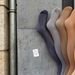 Five colored stockings on a concrete backdrop showcasing diversity in fashion.