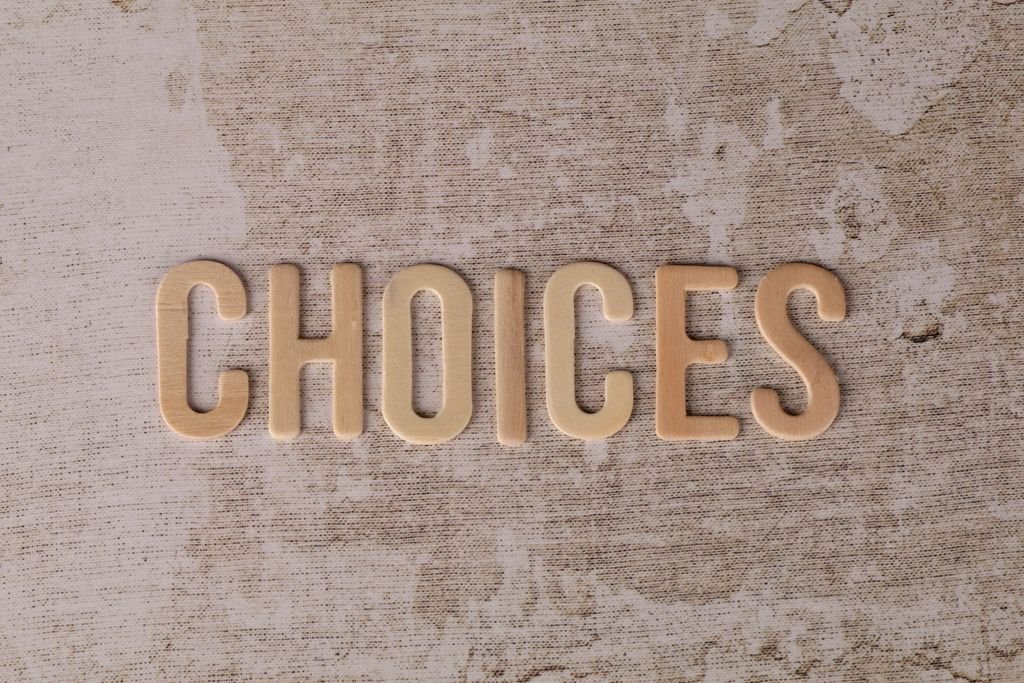 Wooden letters spelling 'choices' on a textured surface, symbolizing decision-making. nylon